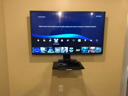 TV Wall Mounted with Shelf below for Playstation 4 and wires hidden
