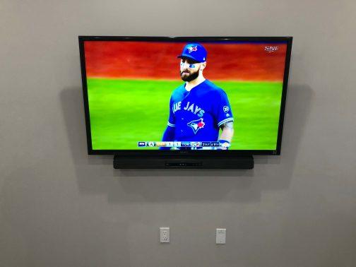 TV Wall Mounted with wires hidden and soundbar installed