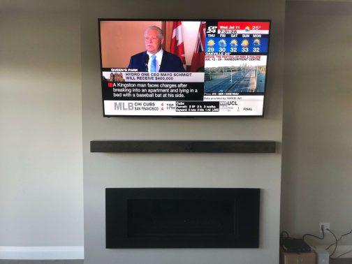 TV Mounted Above fireplace on drywall with wires hidden
