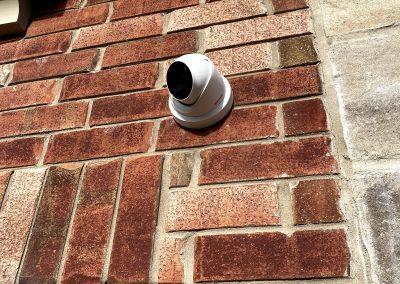 4K White IP Turret Security Camera installed on Brick Wall