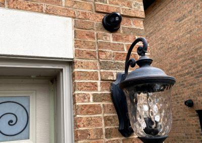 Black IP Turret Security Camera installed on Brick Wall