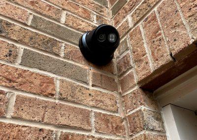 Black IP Turret Security Camera installed on Brick