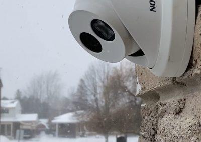 White Hikvision Turret IP Security Camera installed on Brick Wall