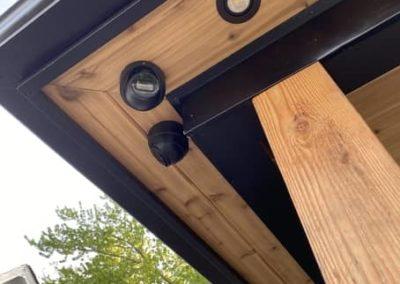Black Turret IP Security Camera installed on wood