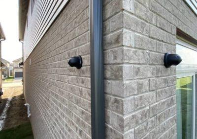 Black IP Turret Camera installed on Brick Wall