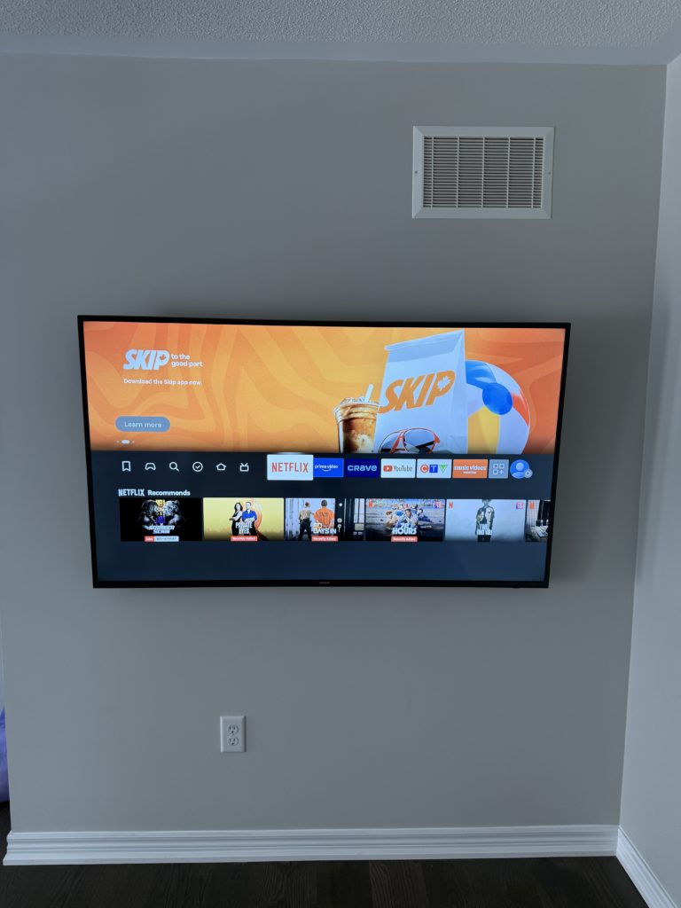 TV mounted neatly on a grey wall by Hamilton Tech Source