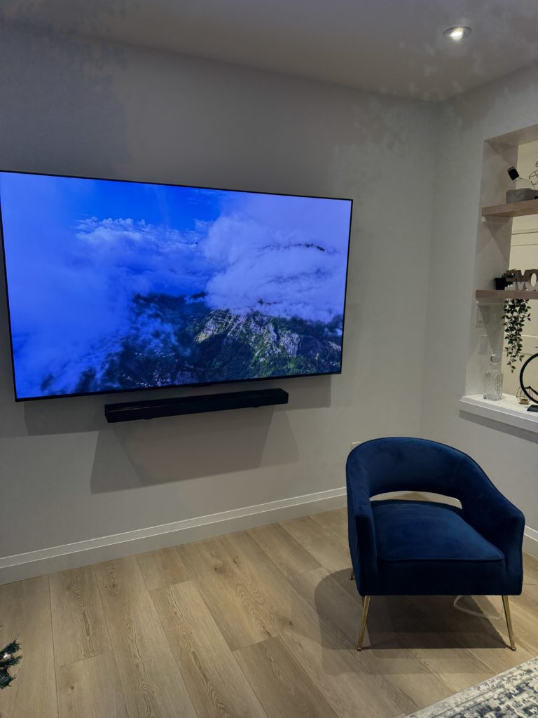 Wall-mounted TV and soundbar in a living room by Hamilton Tech Source